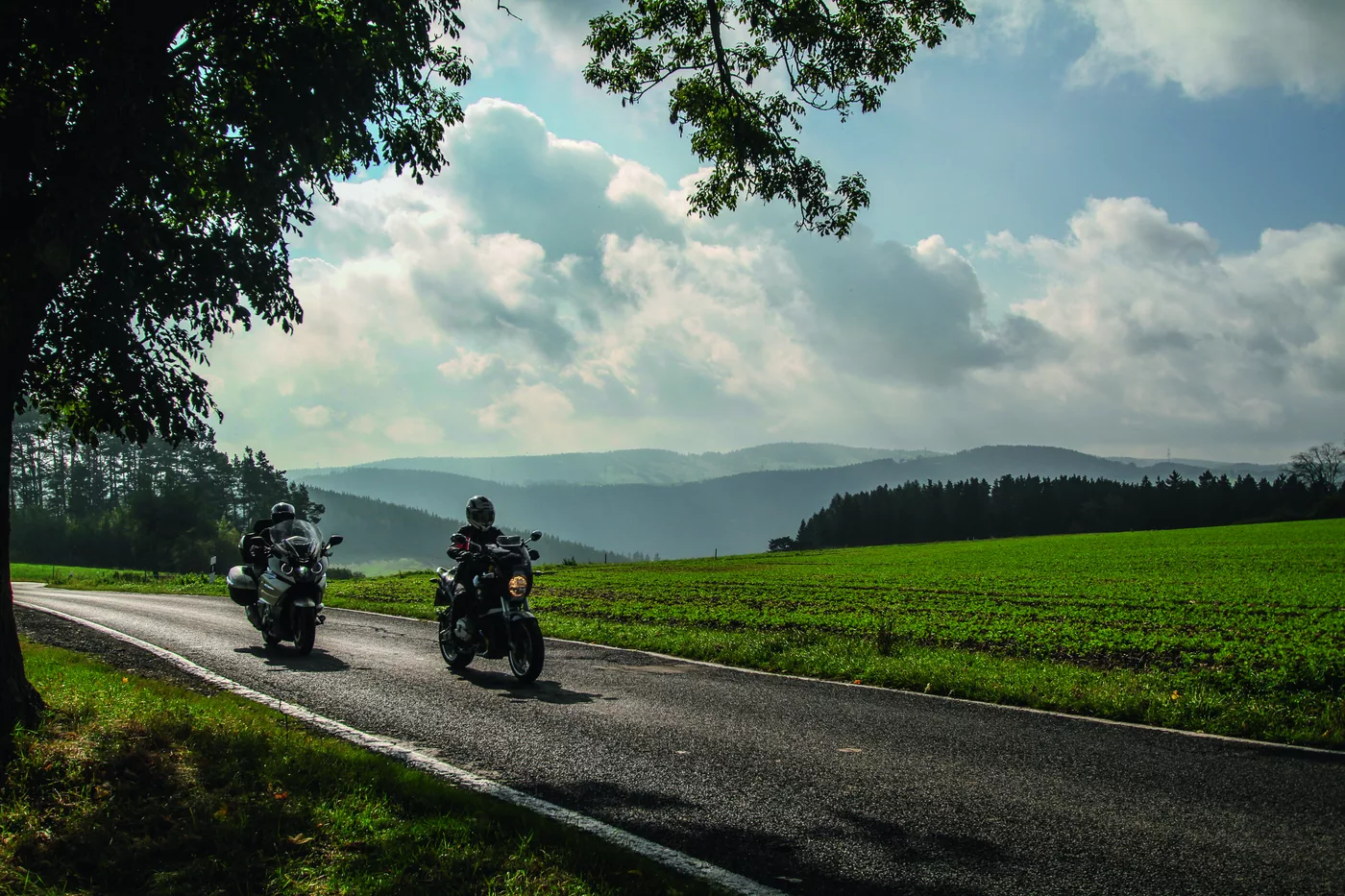 Zwei Motorräder auf einer weiten Landstraße im Thüringer Wald Zwei Motorräder auf einer weiten Landstraße im Thüringer Wald